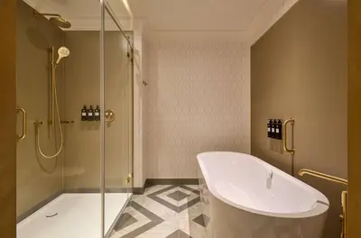 a hallway with white doors and wood floors at Hotel Saski Krakow Curio Collection by Hilton in Kraków