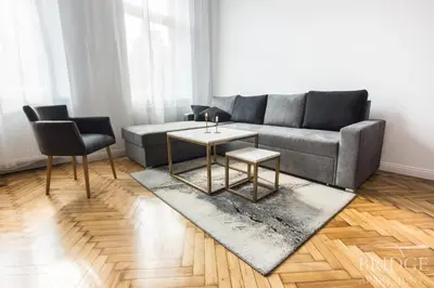a living room with a couch and a table at Bridge Apartments in Kraków
