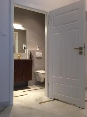 a bathroom with a toilet and a sink at Bridge Apartments in Kraków