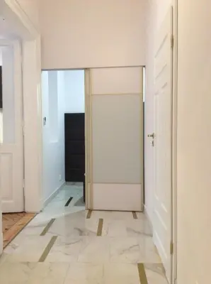 an open door in a room with a tile floor at Bridge Apartments in Kraków