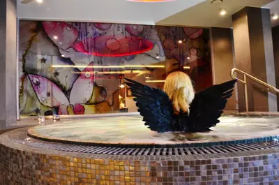 a woman with wings sitting in a fountain in a mall at Hotel Azalia & Spa in Niepołomice