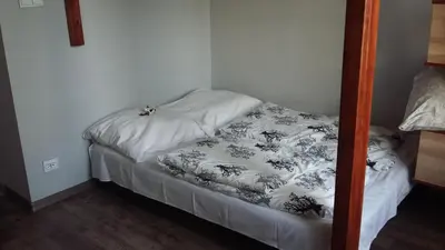a small bed in a corner of a room at Studio Na Powiślu in Kraków