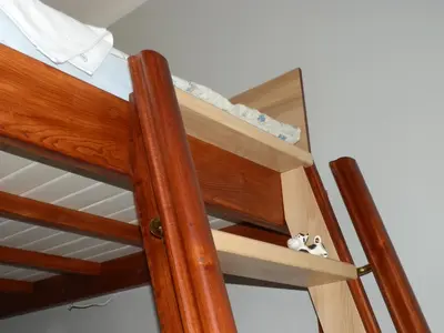 a wooden bunk bed with a ladder in a room at Studio Na Powiślu in Kraków