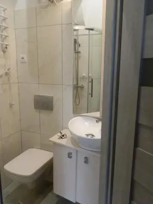 a white bathroom with a sink and a toilet at Studio Na Powiślu in Kraków
