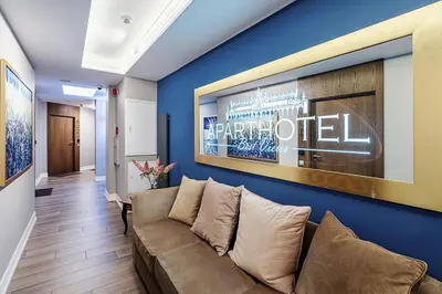 a living room with a couch against a blue wall at Aparthotel Best Views in Kraków