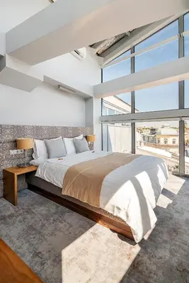 a bedroom with a large bed and a large window at Aparthotel Best Views in Kraków