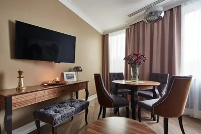 a hotel room with a table and chairs and a television at Aparthotel Best Views in Kraków