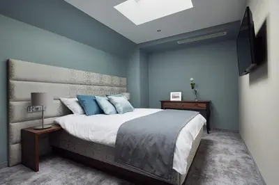 a bedroom with a large bed and a flat screen tv at Aparthotel Best Views in Kraków