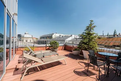 a balcony with chairs and tables on a building at Aparthotel Best Views in Kraków