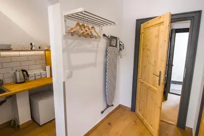 a door leading into a kitchen with a counter and a kitchen at Pokoje Gościnne Św. Anny in Kraków