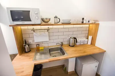 a small kitchen with a sink and a microwave at Pokoje Gościnne Św. Anny in Kraków
