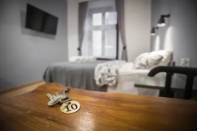 a pair of keys sitting on a wooden table at Pokoje Gościnne Św. Anny in Kraków
