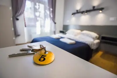 a key on a counter in a room with a bed at Pokoje Gościnne Św. Anny in Kraków