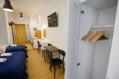 a room with two beds and a table at Pokoje Gościnne Św. Anny in Kraków