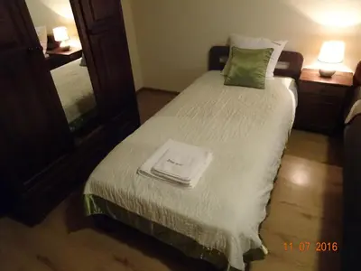 a hotel room with a bed with a mirror at ZłotyOgród in Wieliczka