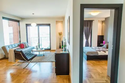 a living room with a couch and a bed in a room at Modern Apartment in City Center in Kraków