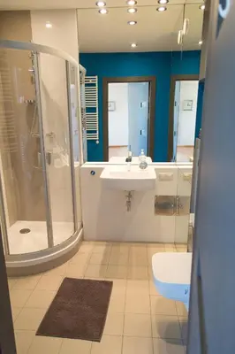 a bathroom with a shower and a sink and a toilet at Modern Apartment in City Center in Kraków