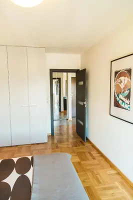 a living room with white walls and wooden floors at Modern Apartment in City Center in Kraków