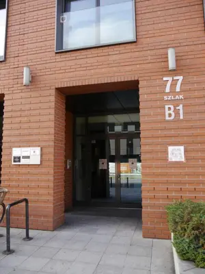 an entrance to a brick building with a sign on it at Modern Apartment in City Center in Kraków