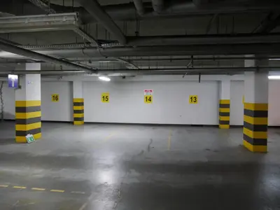 an empty parking garage with yellow and white walls at Modern Apartment in City Center in Kraków