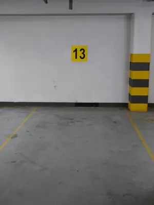 an empty parking garage with a yellow and white wall at Modern Apartment in City Center in Kraków