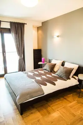 a bedroom with a large bed and a window at Modern Apartment in City Center in Kraków