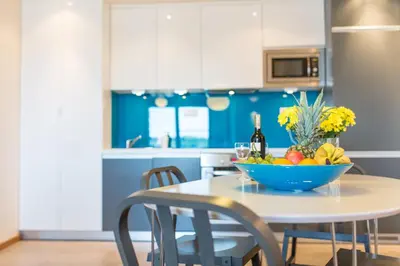 a kitchen with a table with a bowl of fruit on it at Modern Apartment in City Center in Kraków