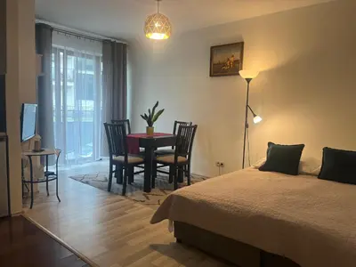 a bedroom with a bed and a table and chairs at Apartament Łagiewniki Krakow in Kraków