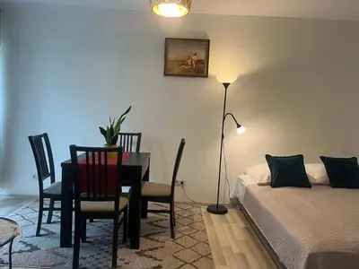 a bedroom with a table and chairs and a bed at Apartament Łagiewniki Krakow in Kraków