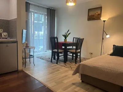 a bedroom with a bed and a table and chairs at Apartament Łagiewniki Krakow in Kraków