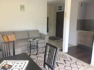 a living room with a couch and a table at Apartament Łagiewniki Krakow in Kraków