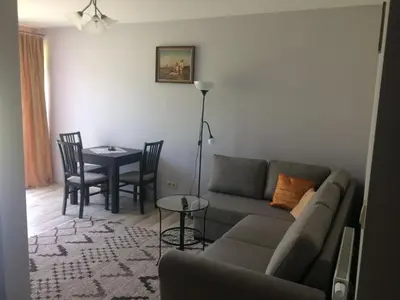 a living room with a couch and a table at Apartament Łagiewniki Krakow in Kraków