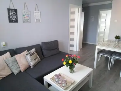a living room with a couch and a table at Apartment Oświęcim klimatyzowany in Oświęcim