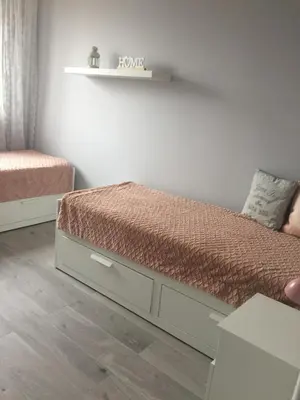 a small bedroom with a bed and a shelf at Apartment Oświęcim klimatyzowany in Oświęcim