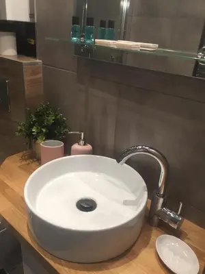 a white sink in a bathroom with a mirror at Apartment Oświęcim klimatyzowany in Oświęcim
