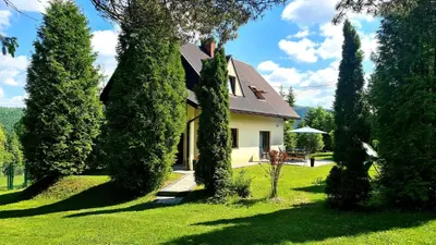 a house with a bunch of trees in the yard at Forest House in Lubomierz