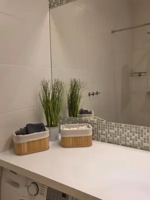 two baskets sitting on a counter in a bathroom at Apartament Vistula in Kraków