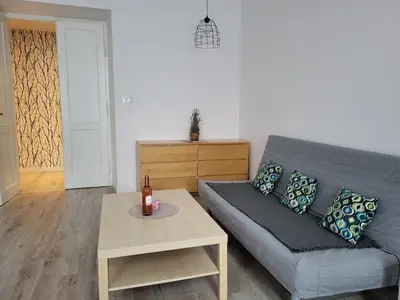 a living room with a couch and a table at Apartament Vistula in Kraków