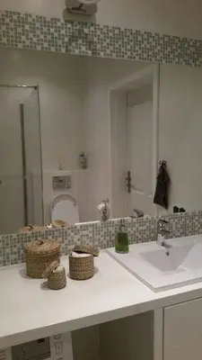 a bathroom with a sink and a mirror at Apartament Vistula in Kraków