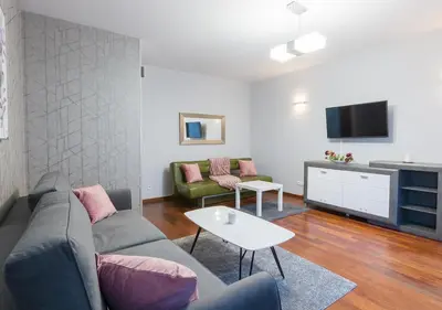 a living room with a couch and a tv at AR Apartments - Angel Center Kraków in Kraków