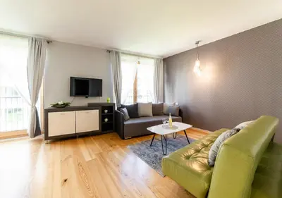 a living room with a couch and a table at AR Apartments - Angel Center Kraków in Kraków