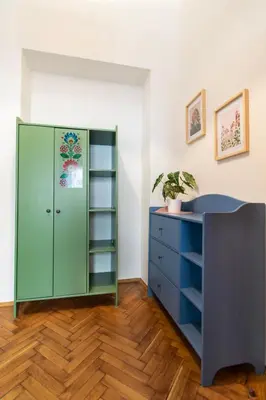 a room with a green cabinet and a blue dresser at Ground Floor Family Apartment in Kraków