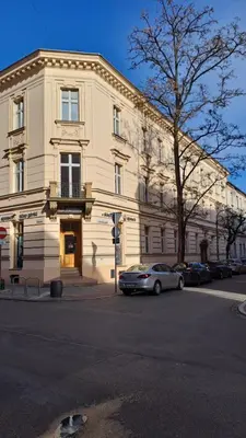 a building with a car parked in front of it at Ground Floor Family Apartment in Kraków