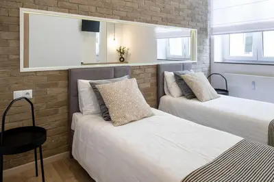 two beds in a small room with a mirror at Beautiful Apartment with 2 bedrooms for 7 guests, Jewish District in Kraków