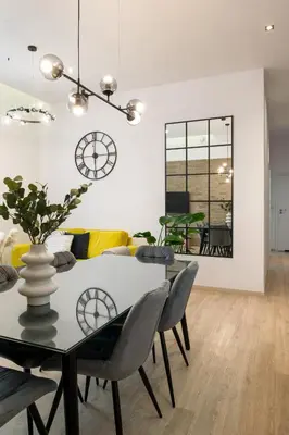 a dining room with a table and chairs at Beautiful Apartment with 2 bedrooms for 7 guests, Jewish District in Kraków