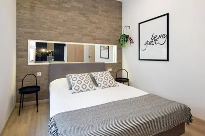 a bedroom with a large bed and a window at Beautiful Apartment with 2 bedrooms for 7 guests, Jewish District in Kraków