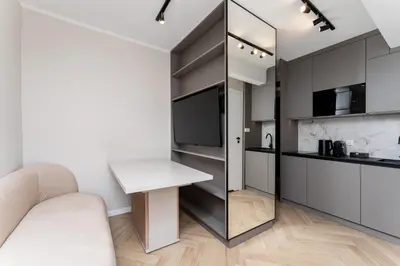 a living room with a white couch and a table at Erasmus Student Apartments - Old Town in Kraków