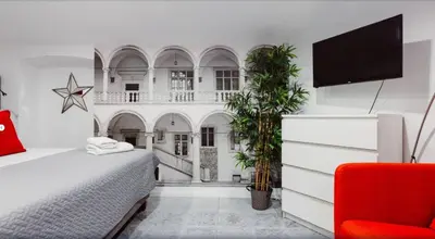 a bedroom with a bed and a flat screen tv at Erasmus Student Apartments - Old Town in Kraków