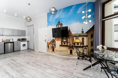 a kitchen with a wall mural of a church at Erasmus Student Apartments - Old Town in Kraków