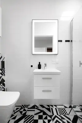 a white bathroom with a sink and a mirror at Rakowicka 71 Partnerapart in Kraków